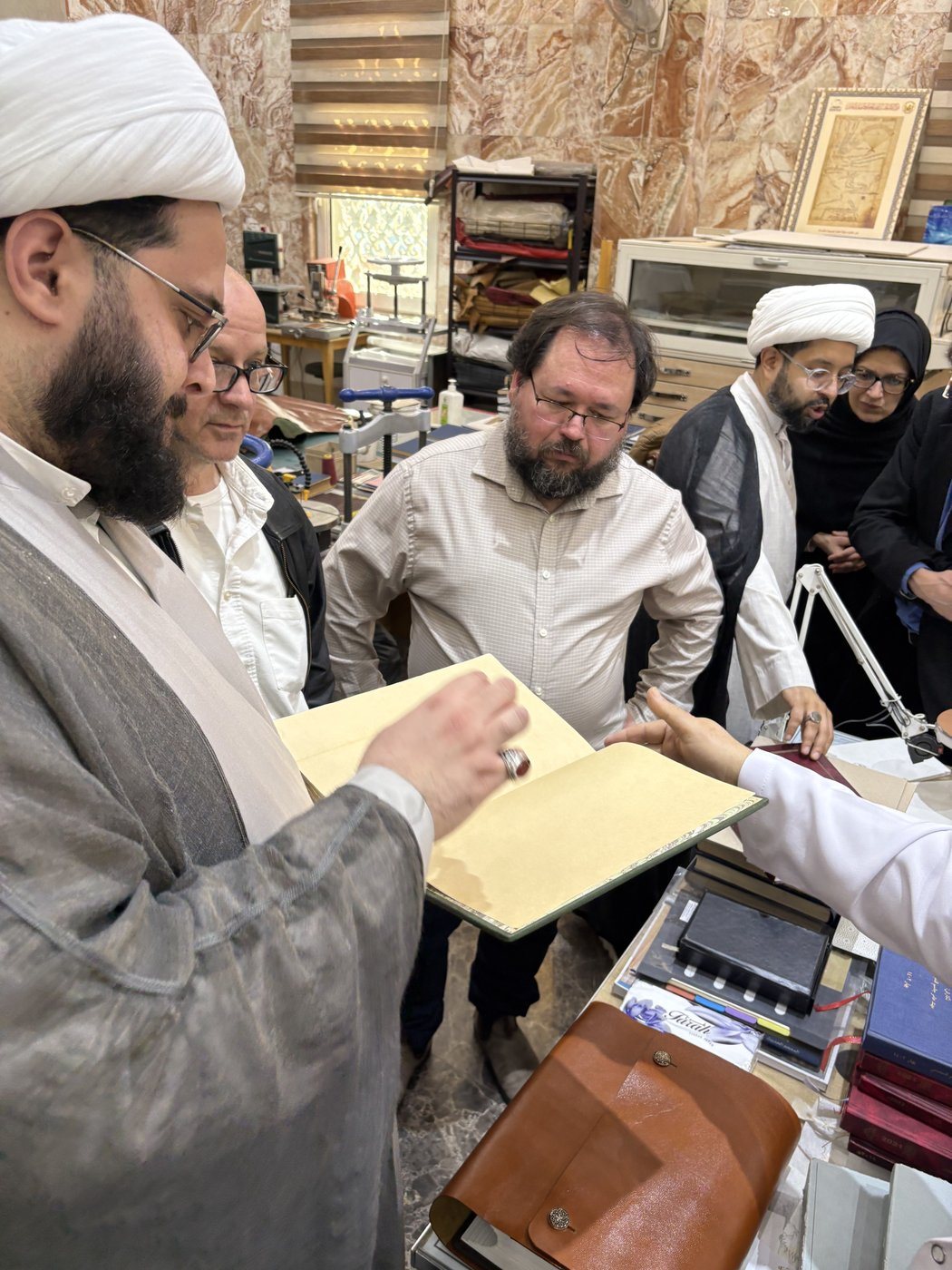 Dr. Hewko looks on as a manuscript is examined in the shrine library, Karbala.