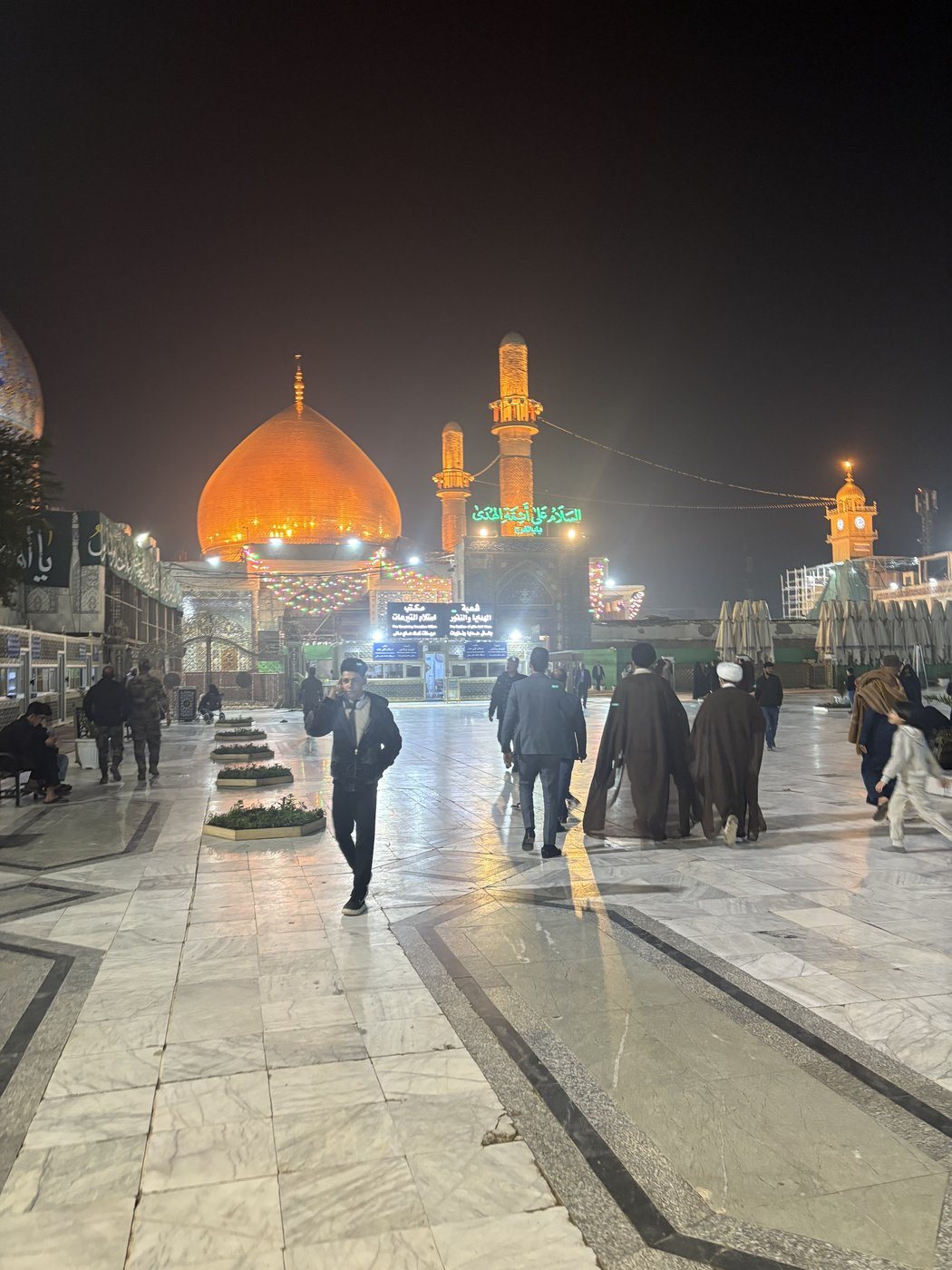 Crossing the courtyard toward the golden dome of al-‘Askari Shrine, Samarra.