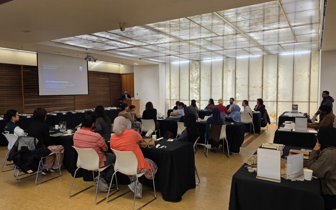 Audience seated at tables during a presentation at A Taste of Islamic Shi'a Life