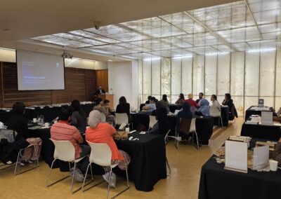 Audience seated at tables during a presentation at A Taste of Islamic Shi'a Life