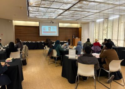 Students listening to a presentation on manuscripts, with manuscript images on screen