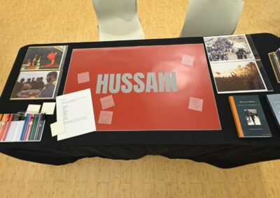 Overhead view of the Story Table's Hussain display with handwritten notes from guests