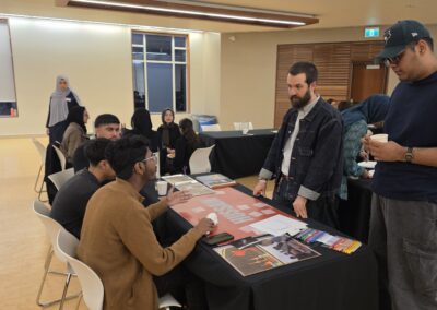 Students gathered around the Story Table exploring its materials